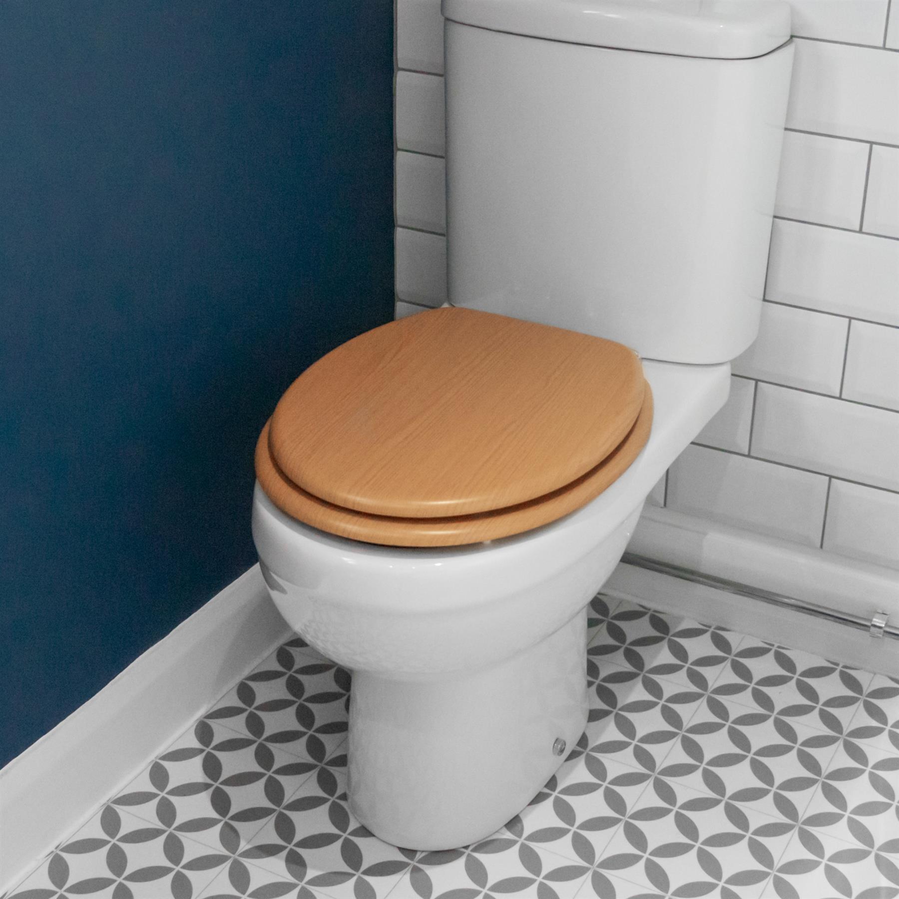 Brown soft-close tongue and groove MDF wood toilet seat showing seat in place on a white ceramic toilet