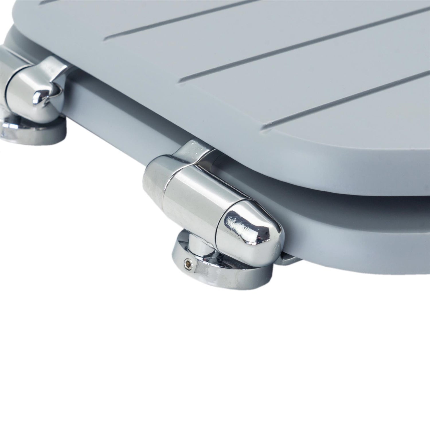 Close-up of chrome-plated soft-close hinges on a grey soft-close tongue and groove MDF wood toilet seat