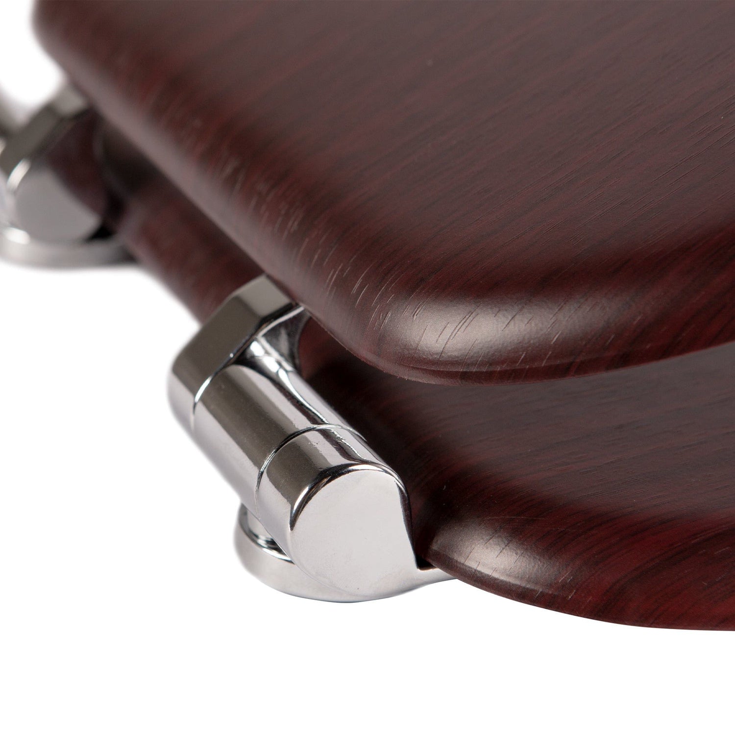 Close-up of chrome-plated soft-close hinges on a mahognay soft-close tongue and groove MDF wood toilet seat